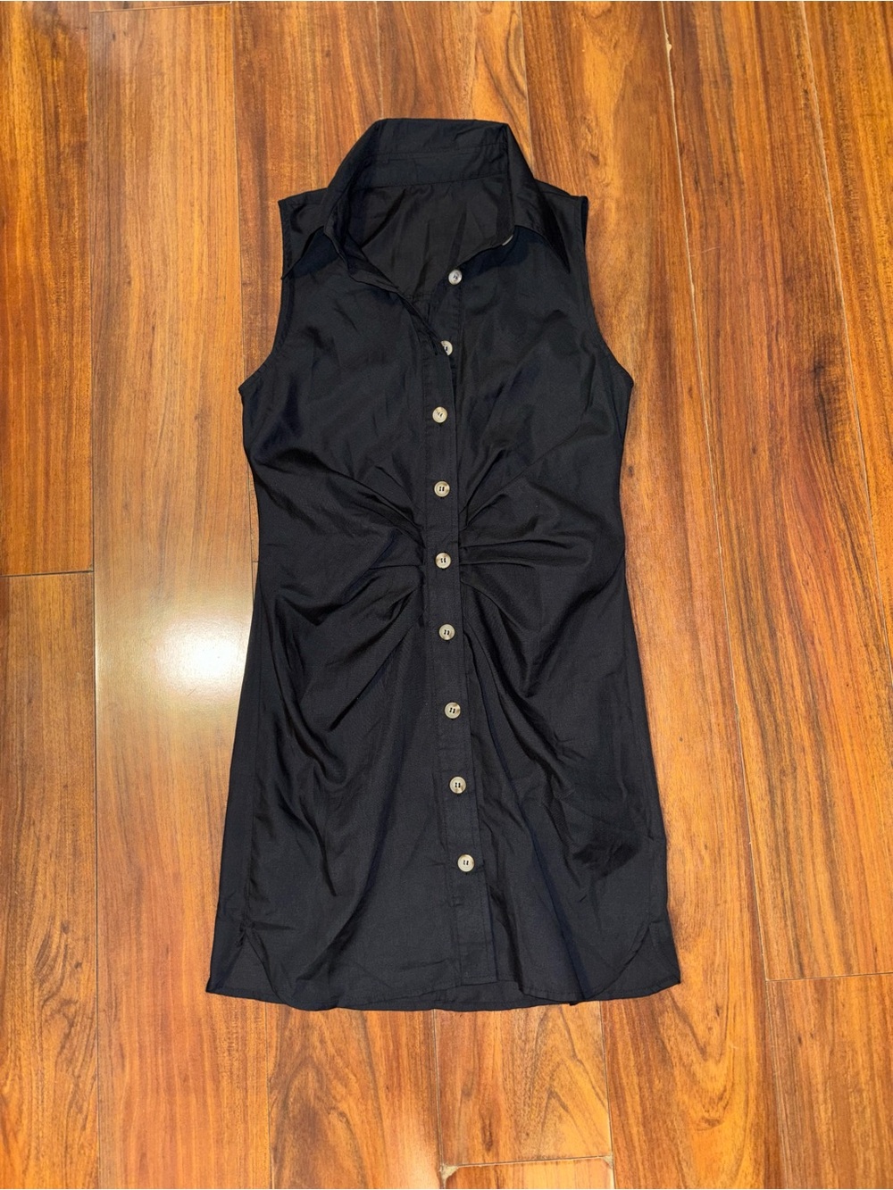 Sleeveless Black Button-Down Mini Dress with Twist Waist Detail